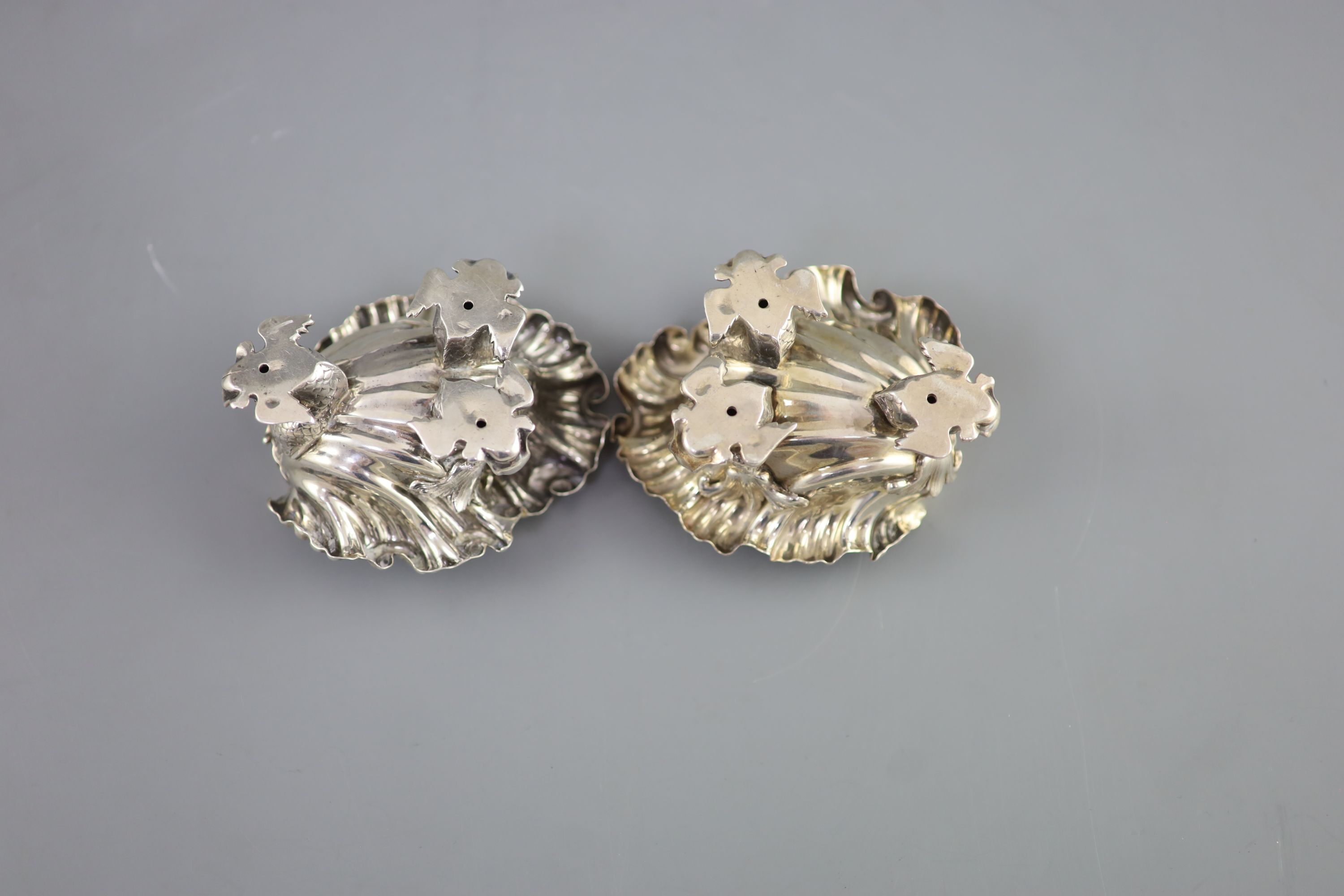 A pair of George IV silver shell shaped salts, by Paul Storr